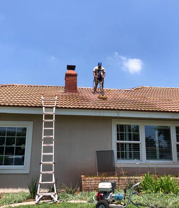 A Big Wave service professional performing roof cleaning and restoration