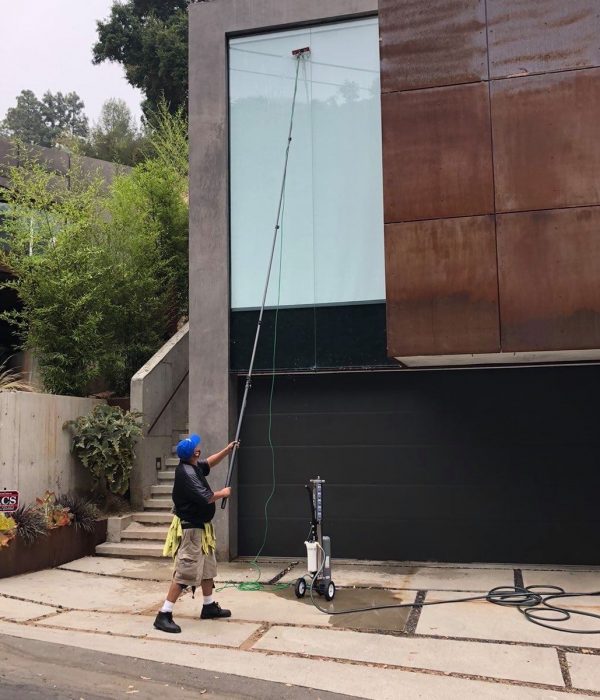 Big Wave Window service professional cleaning a window with a water-fed pole