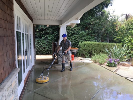 A Big Wave service professional performing flat surface concrete cleaning