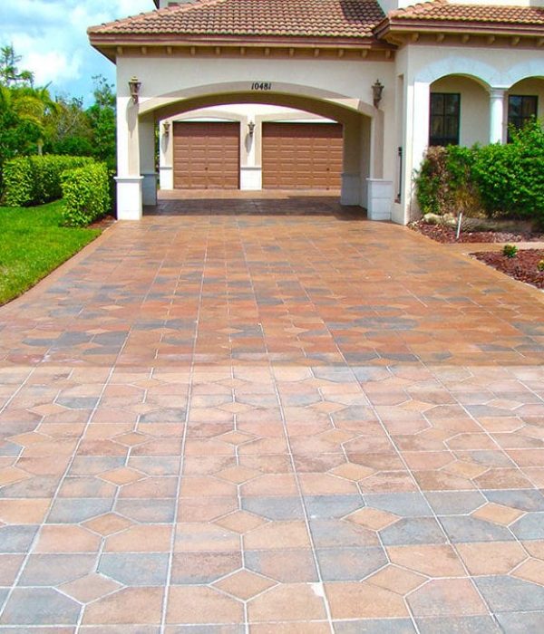 A half finished driveway displaying the difference between before and after paver sealing