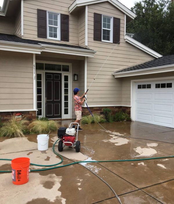 Big Wave Window technician soft pressure washing a roof